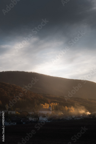 Vertical shot of houses and a mountain in the background