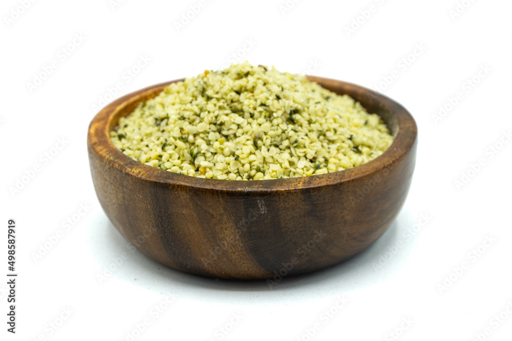Hemp seeds in wooden bowl isolated on white background Hemp seeds in wooden bowl isolated on white background
