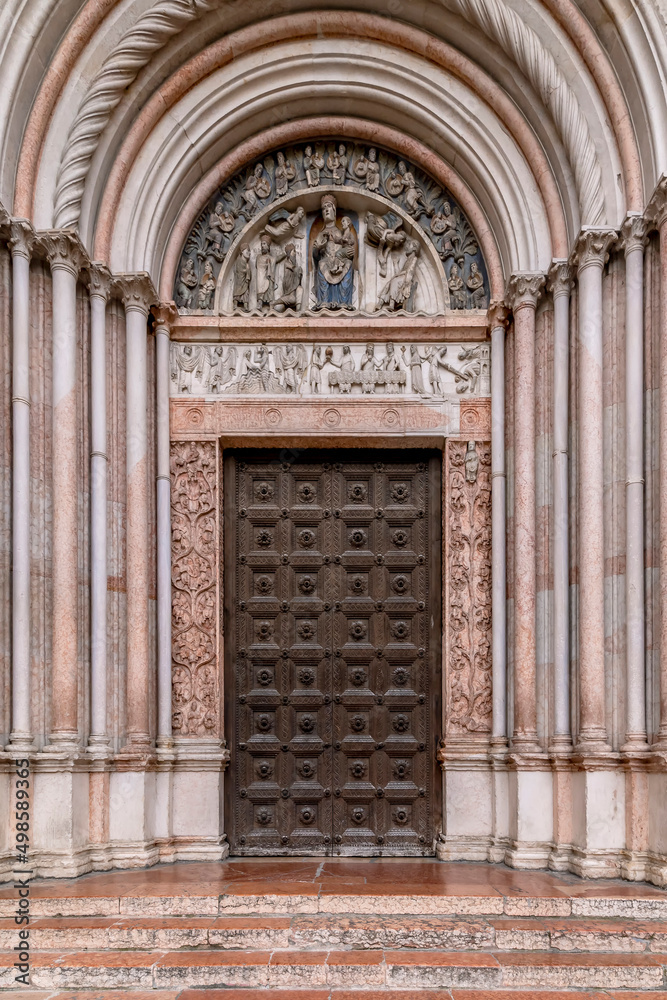 The entrance portal of the ancient baptistery, historic center of Parma, Italy