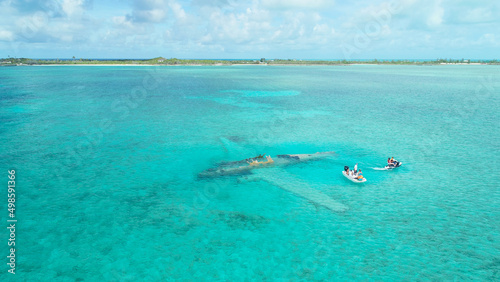 Tablou pe pânză Aerial view of people  in a white tiny boat at Exumas, Bahamas