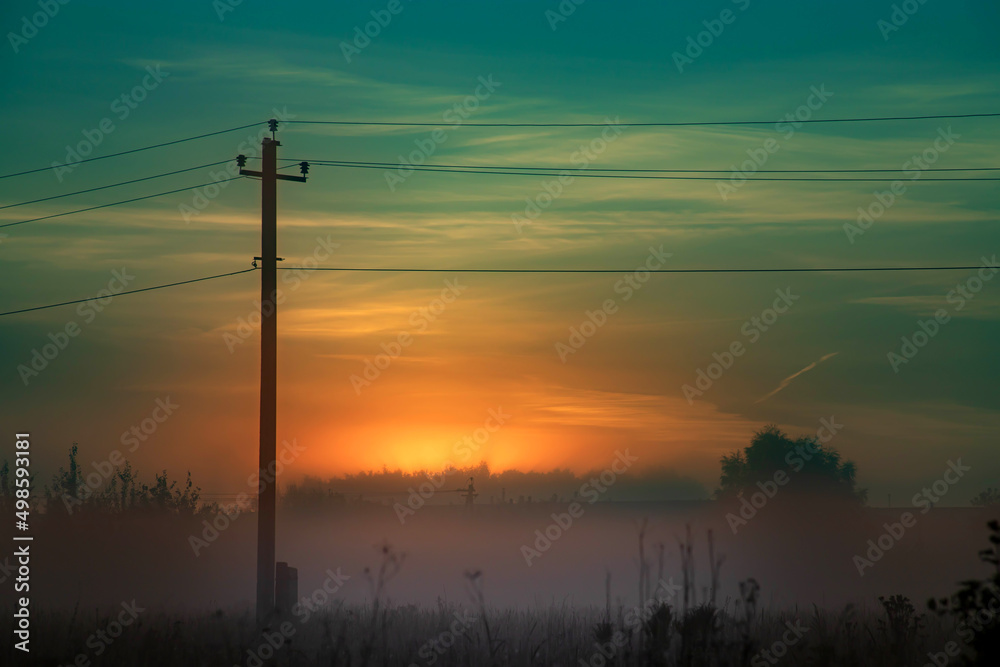 Silhouette of old electrical lines, old telephone cables and light at the golden hour on the sunrise.