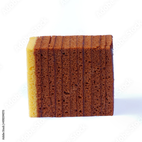 Tableau sur toile Closeup shot of chocolate layered sponge cake slice isolated on a white backgrou