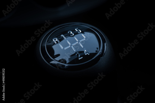 Closeup shot of the manual gear shifter isolated on  dark background photo