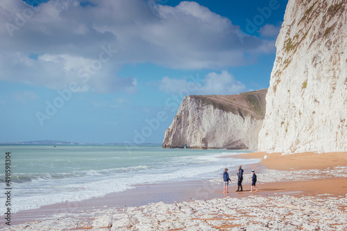 Family on the sunny day on the Jurassic Coast beach, Dorset, UK