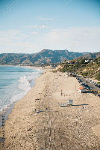 Aerial view of Zuma Beach and mountains against blue sky on a sunny day in Malibu, California, USA