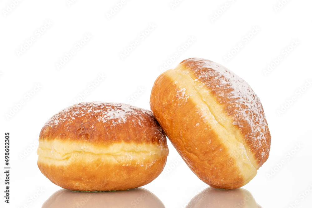 Two sweet donuts stuffed with jam, macro, isolated on a white background.