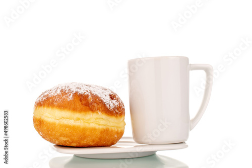 One sweet donut with jam filling with a white ceramic cup on a saucer, close-up, isolated on a white background.
