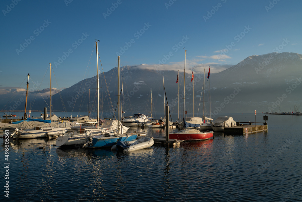 Winter landscape of lake Maggiore with boats in Locarno, Switzerland