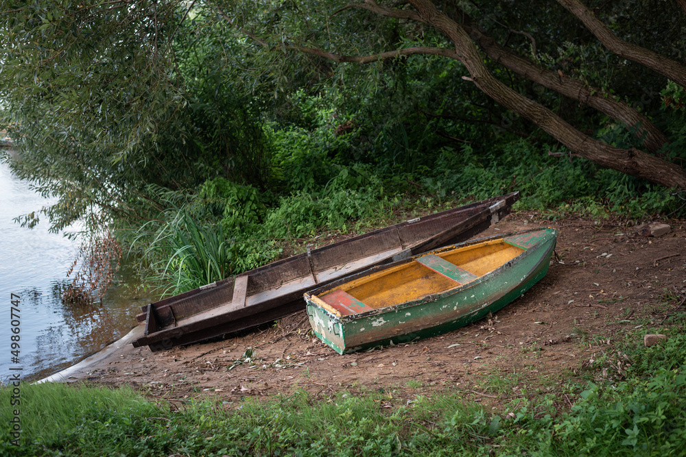 Scenic landscape. Old wooden boats on the sandy bank of the river. Scenic landscape. Old wooden boats on the sandy bank of the river.