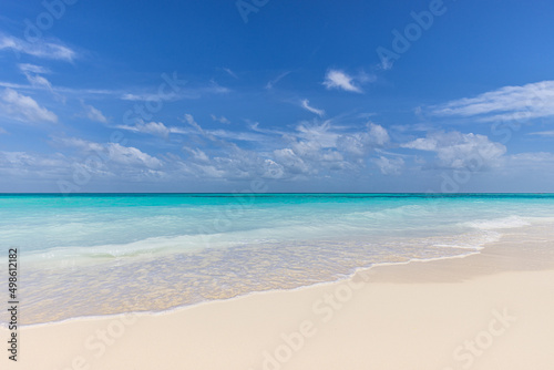 Closeup of sand on beach and blue summer sky. Panoramic beach landscape. Empty tropical beach and seascape. Blue sky clouds, soft sand, calmness, tranquil relaxing sunlight, summer tranquil mood