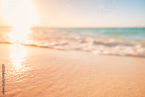 Fototapeta Naklejka Na Ścianę i Meble -  Closeup waves and sea sand, paradise beach landscape. Inspire tropical beach seascape horizon. Orange and golden sunset sky, blurred calmness tranquil relaxing sunlight summer. Vacation travel holiday