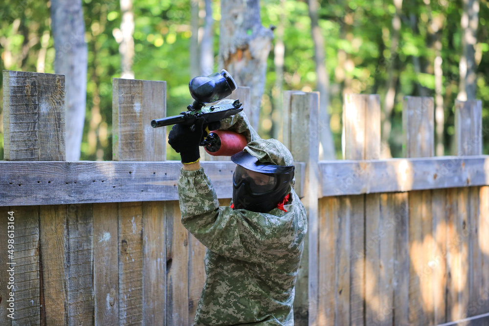 Paintball player in full gear at the shooting range Paintball player in full gear at the shooting range