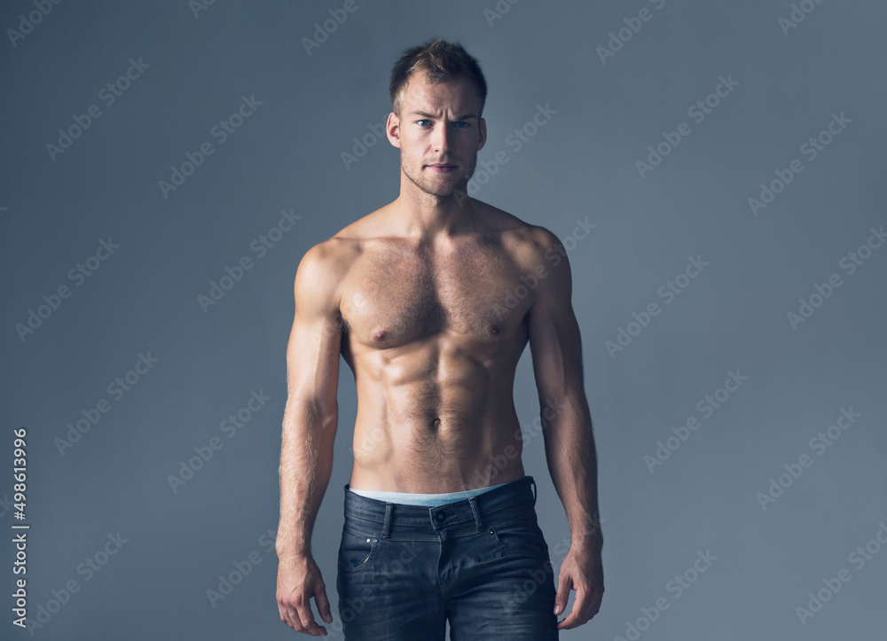 Broody and handsome. Studio shot of a shirtless muscular man wearing jeans.