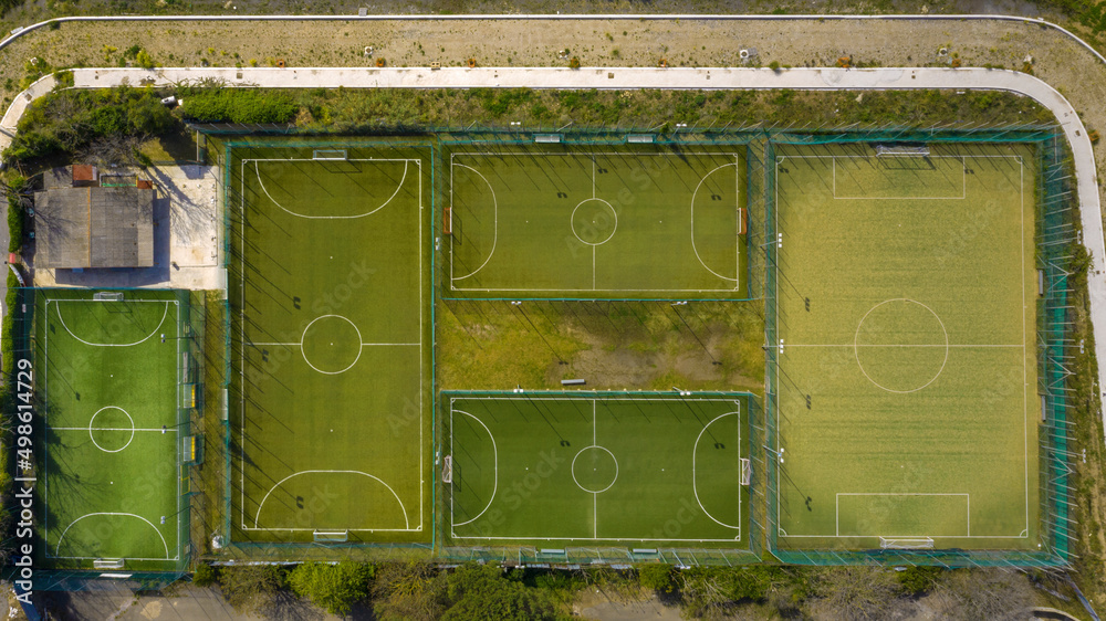 Orthogonal aerial view on a sports center with many soccer and fivea