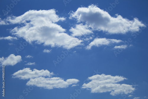 Beautiful scattered cumulus white clouds against the blue sky, copy space. Blue sky with clouds, free space. Texture. The background.