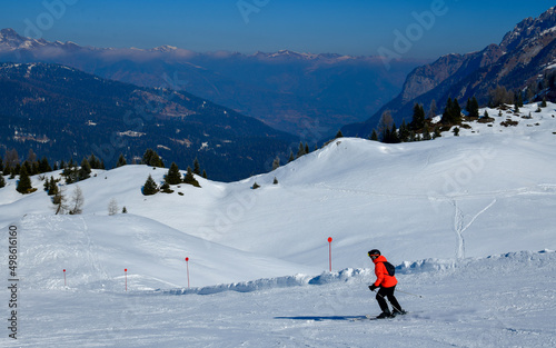 Skiing on a beautiful sunny day at Madonna di Campiglio Ski Resort, located at the area of the Brenta Dolomites in Italy, Europe.