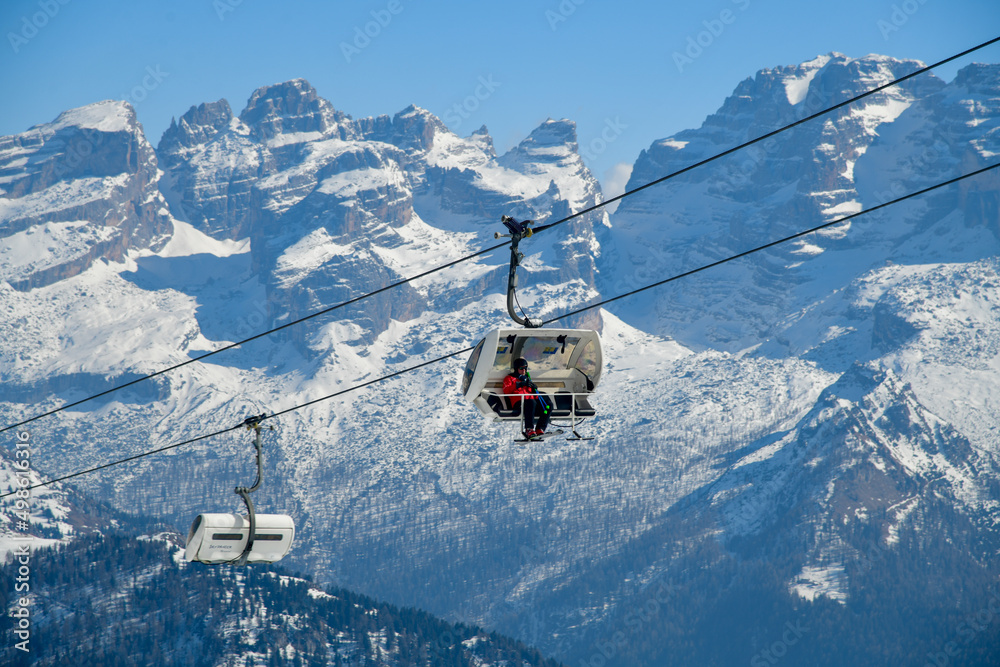 Chairlift running to the top at Madonna di Campiglio Ski Resort, located at the area of the Brenta Dolomites in Italy, Europe.