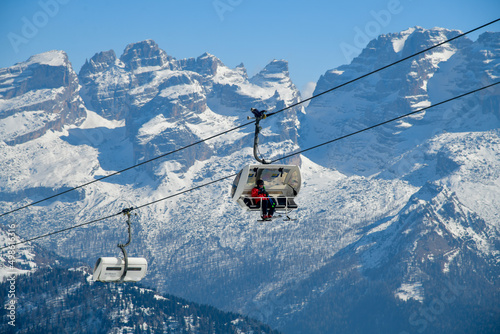 Chairlift running to the top at Madonna di Campiglio Ski Resort, located at the area of the Brenta Dolomites in Italy, Europe.