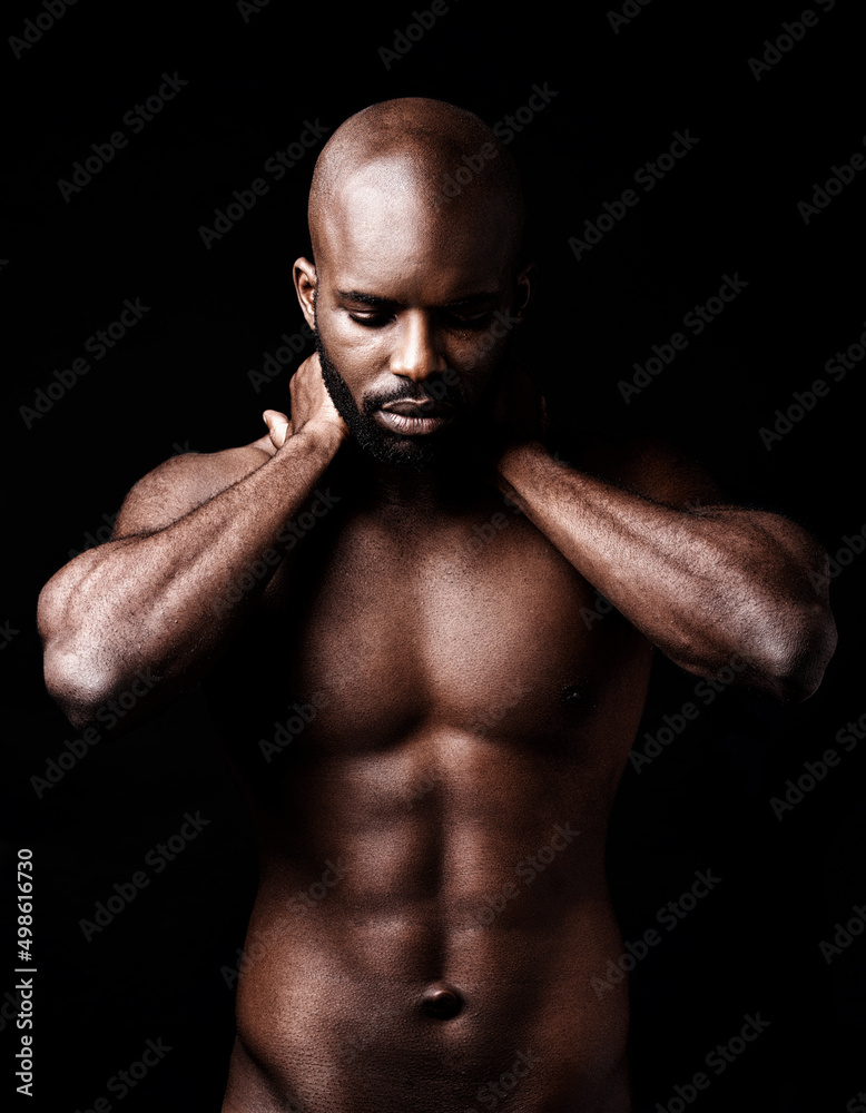 Six pack perfection. Studio shot of a muscular man closing his eyes while holding his neck.