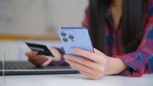 Woman buying online with a credit card and mobile phone app