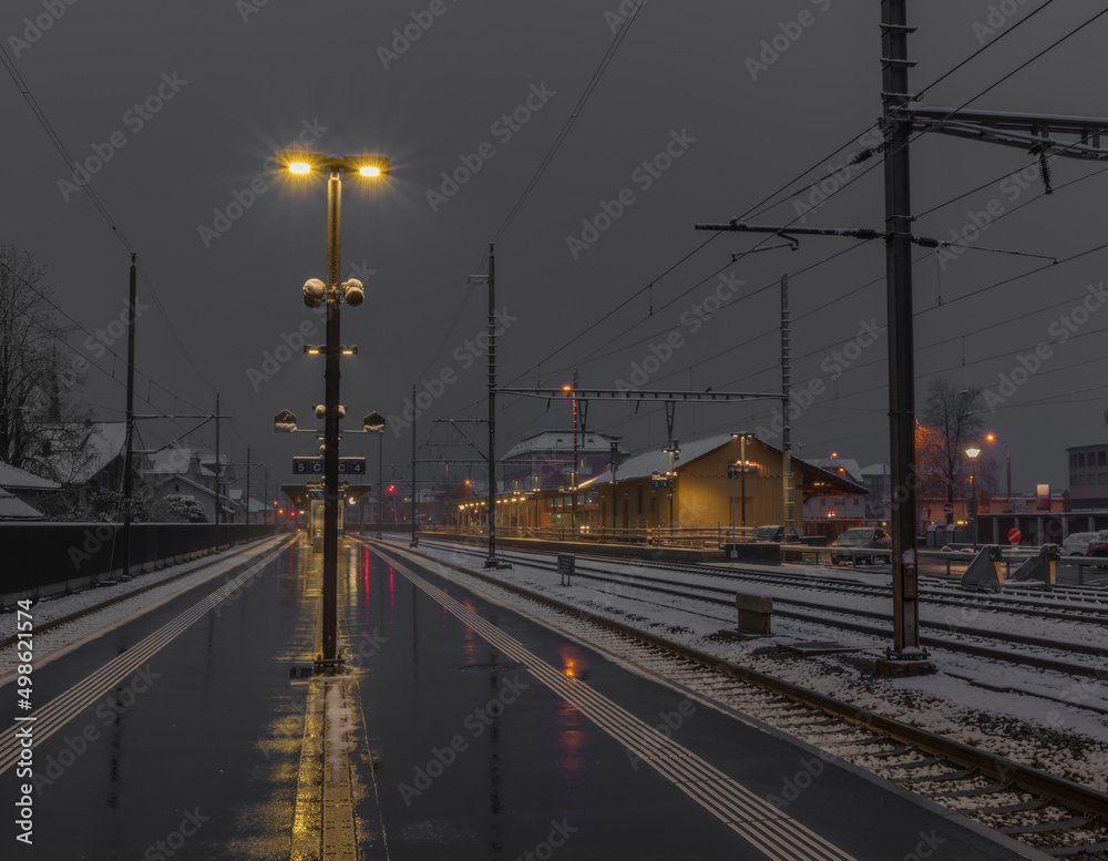 Very bad weather in Brunnen station in spring snowy morning