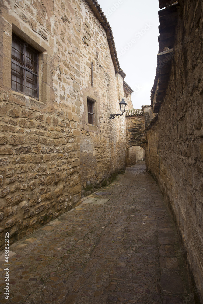 A narrow street in a medieval district of the city with a cobbled stone street. Úbeda, Spain.