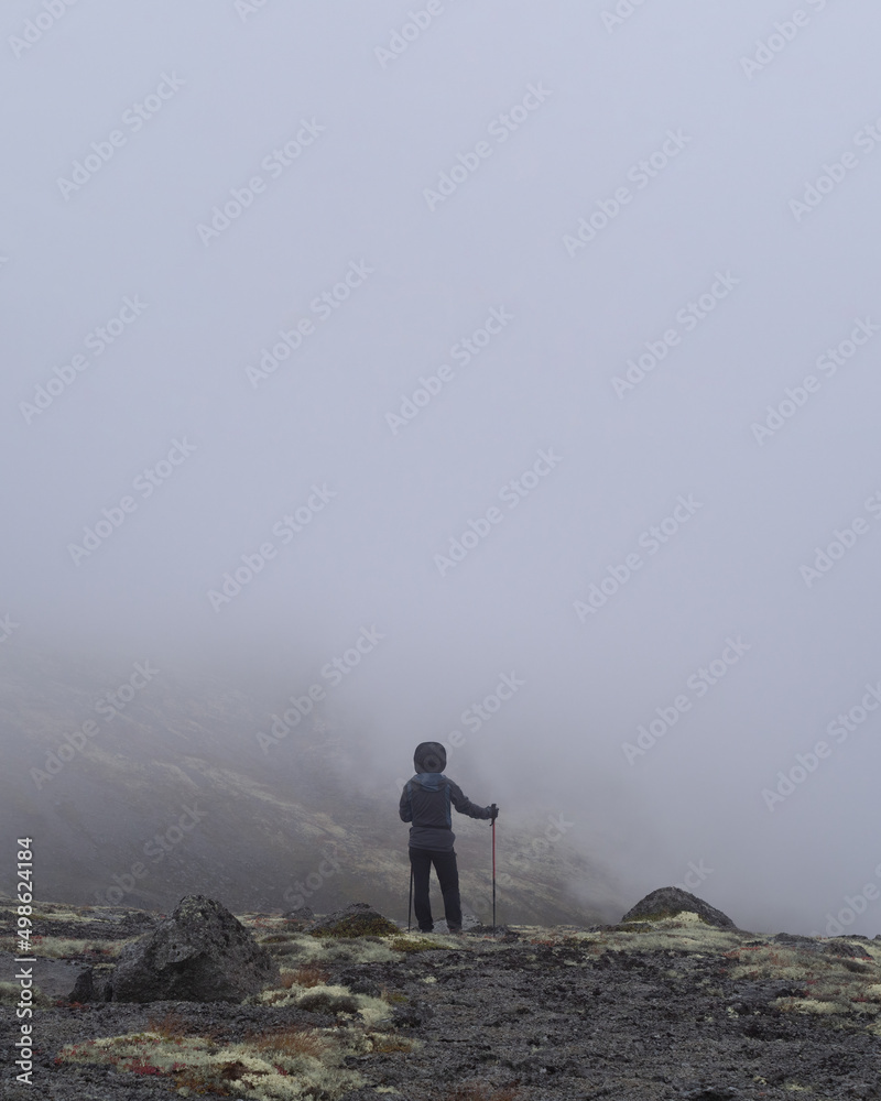A young girl in the mountains goes into the clouds. dense clouds A young girl in the mountains goes into the clouds. dense clouds
