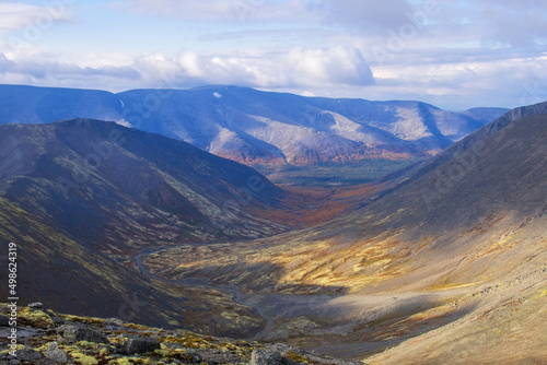 Autumn colorful tundra on the background mountain peaks. Mountain landscape in Kola Peninsula, Arctic, Khibiny Mountains.