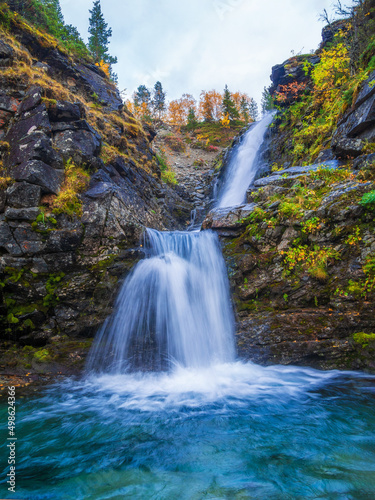 Beautiful mountain waterfall among rocks in polar summer in Khibiny Mountains. Kola Peninsula, Arctic, polar summer