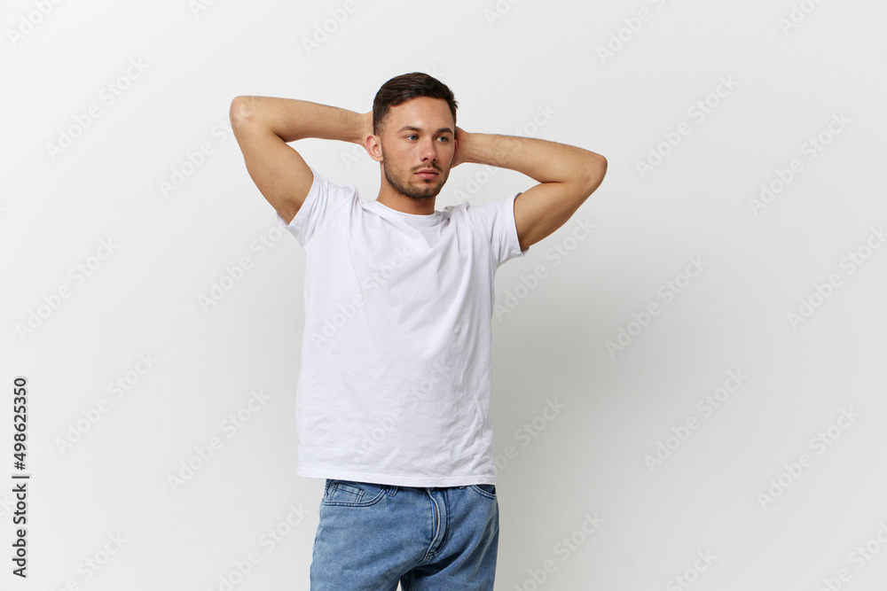 Young sexy happy tanned handsome man in basic t-shirt folded hands behind head posing isolated on over white studio background. Copy space Banner Mockup. People emotions Lifestyle concept Young sexy happy tanned handsome man in basic t-shirt folded hands behind head posing isolated on over white studio background. Copy space Banner Mockup. People emotions Lifestyle concept