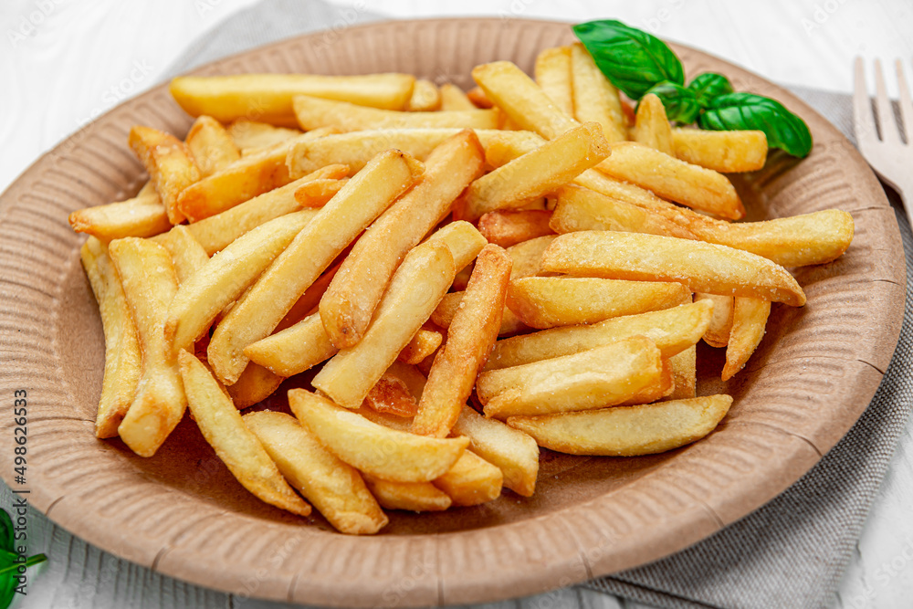 French fries. Fried potatoes on a paper plate. French fries. Fried potatoes on a paper plate.