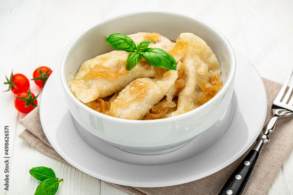 Boiled dumplings on a white plate close-up. Vareniki. Boiled dumplings on a white plate close-up. Vareniki.