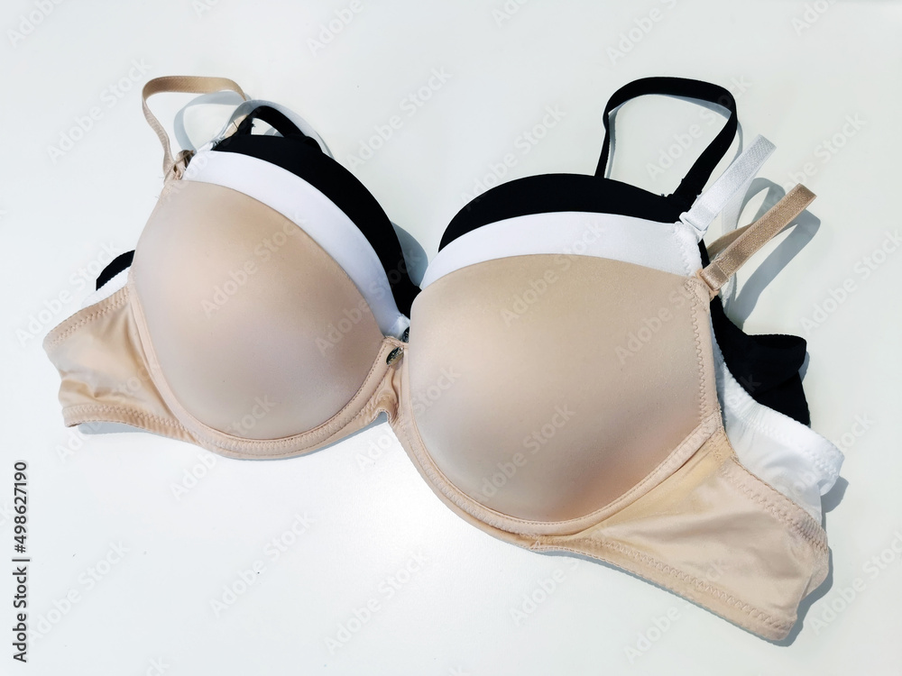 Bras with a molded cup in beige, white, black colors on a white background. Basic collection of lingerie. Bras with a molded cup in beige, white, black colors on a white background. Basic collection of lingerie.
