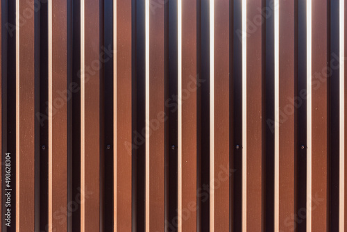 Brown vertical metal fence background.