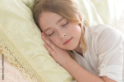 Cute little girl sleeping in bed at home