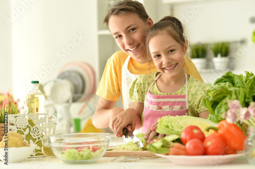 Cute brother and sister cooking