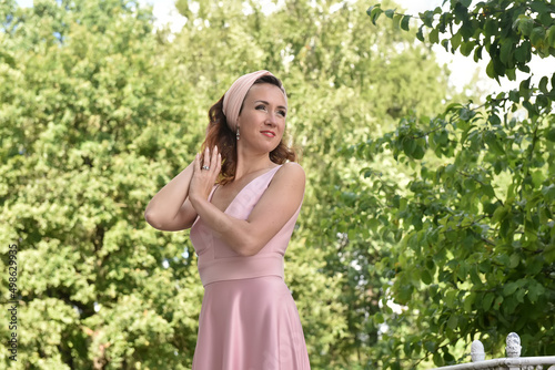 beautiful elegant brunette woman in pink dress