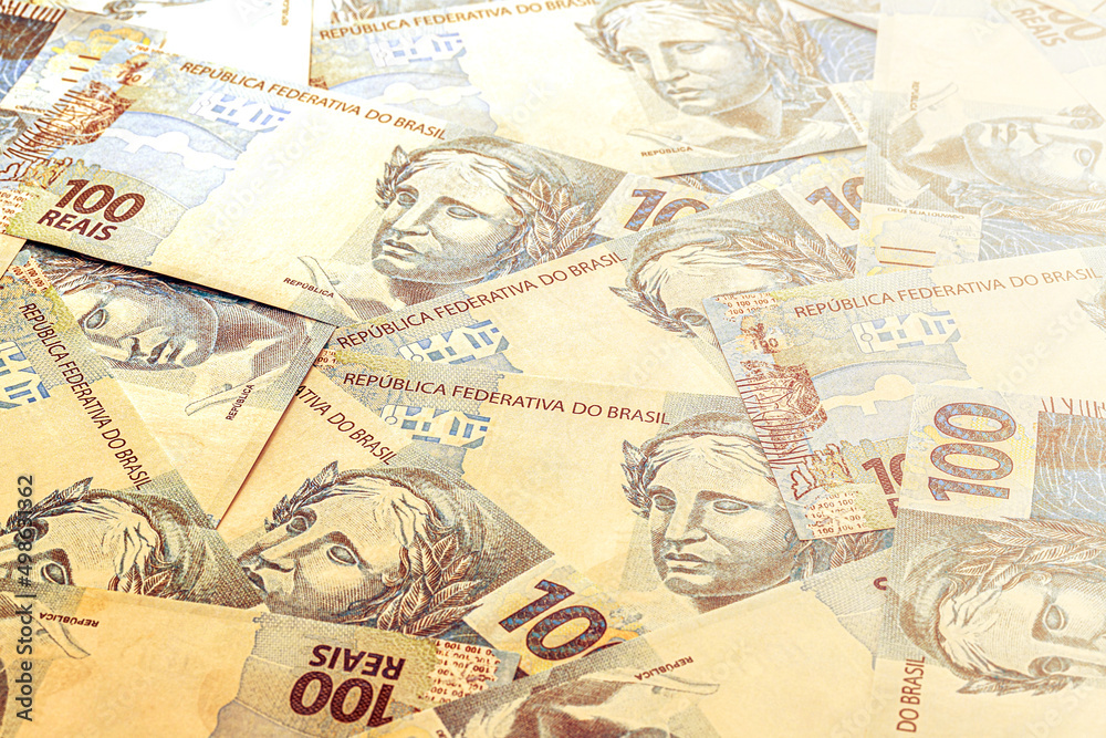 several hundred reais bills from brazil, more than one thousand reais in prize, brazilian money in background