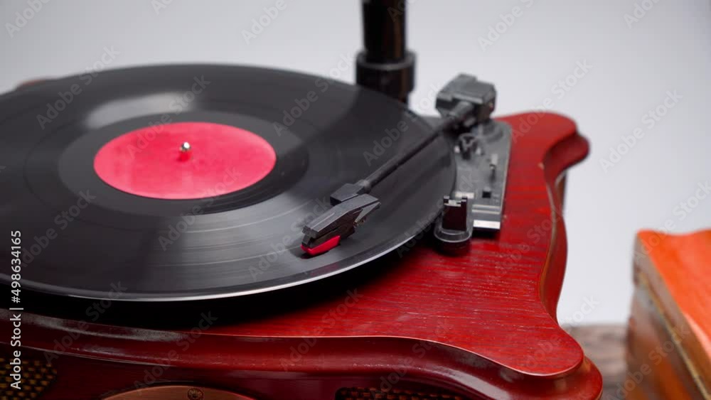 Vinyl record player in action. Old school style cinemagraph loop vinyl record player. Close up view of vintage plate player. Old style sound technology to play music. Rotating vintage phonograph 