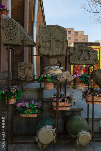 Stone plates and flowers in a yard of Zoravor Surp Astvatsatsin Church is the oldest surviving church in Yerevan, Armenia photo