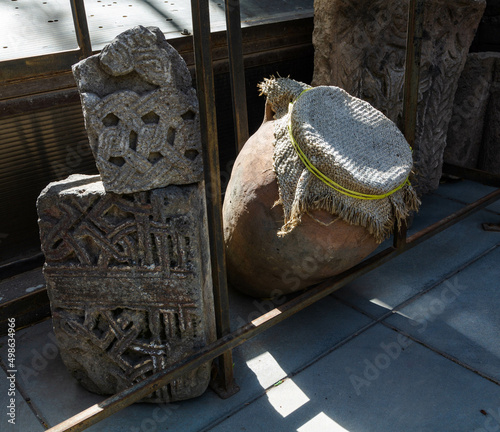 Stone plates and flowers in a yard of Zoravor Surp Astvatsatsin Church is the oldest surviving church in Yerevan, Armenia photo