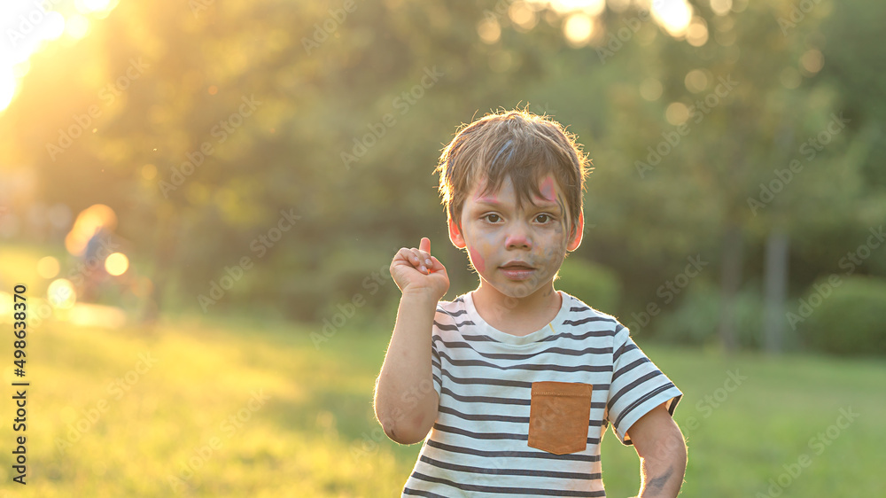 Portrait of a little boy who raised his finger up, photo in nature with copy space Portrait of a little boy who raised his finger up, photo in nature with copy space