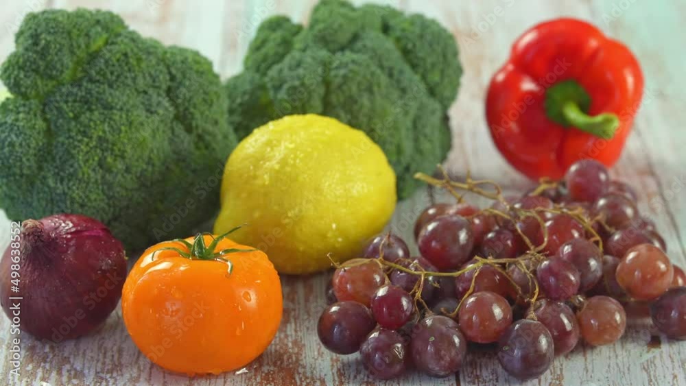 Group shot of fruits and vegetables. A drop of water falls on a tomato. slow motion 4k video close up Group shot of fruits and vegetables. A drop of water falls on a tomato. slow motion 4k video close up