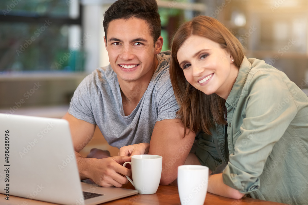 Weekends are for wifi and being together. Portrait of a happy young couple using their laptop while having coffee in their kitchen at home. Weekends are for wifi and being together. Portrait of a happy young couple using their laptop while having coffee in their kitchen at home.