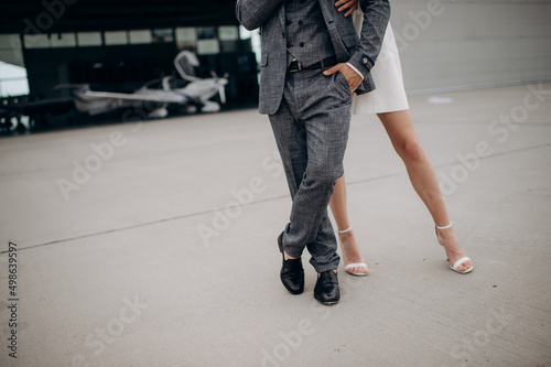 a couple of newlyweds are standing, legs in shoes close-up