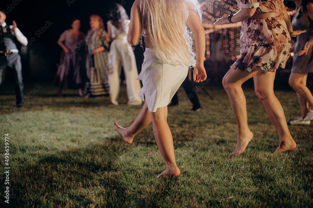 Fototapeta premium feet of dancing people in a disco at a banquet
