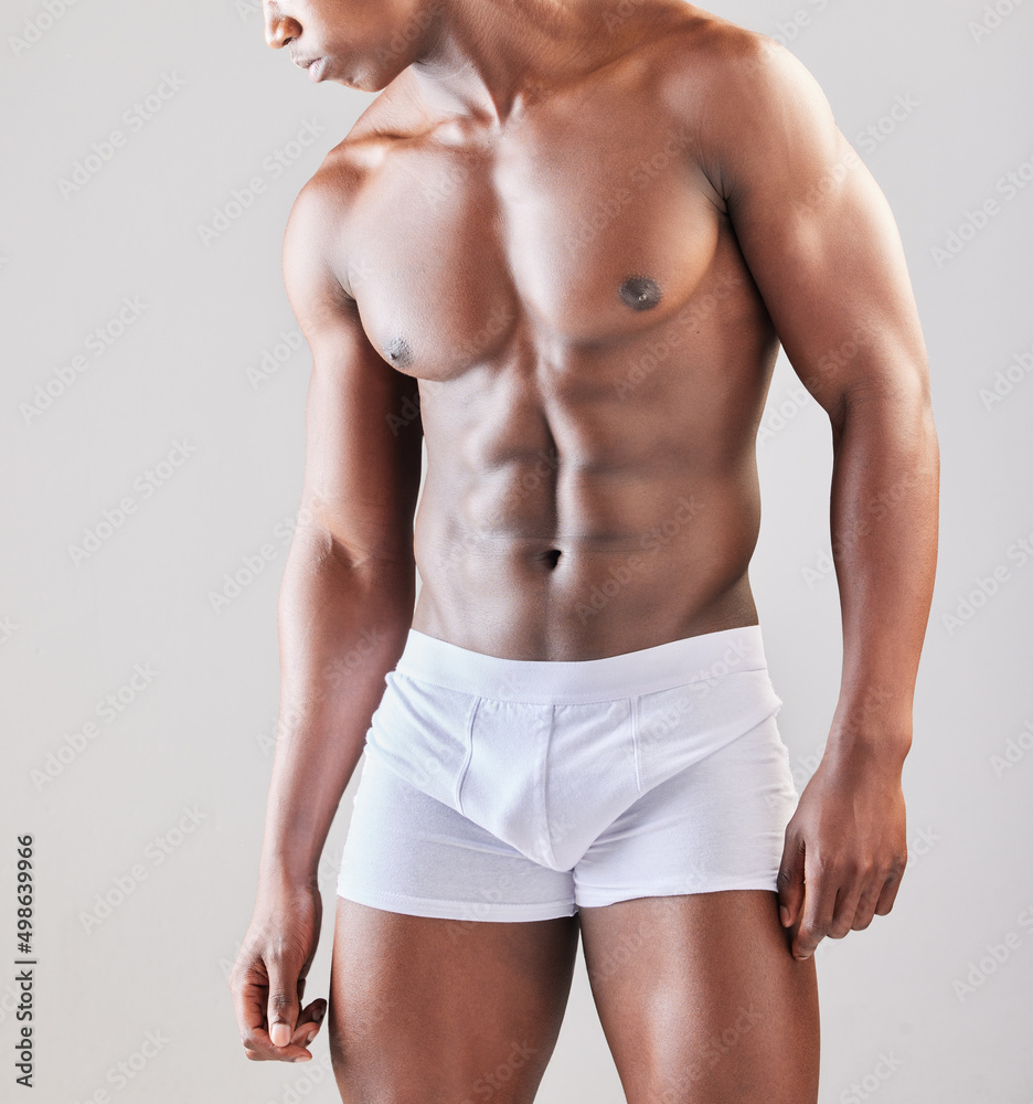 A different shade of glory. Cropped shot of a muscular man posing against a grey background. A different shade of glory. Cropped shot of a muscular man posing against a grey background.