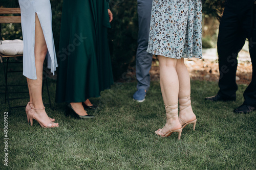 legs of bridesmaids in elegant evening dresses at a bachelorette party © Юлия Чернецкая