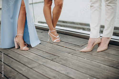 legs of bridesmaids in elegant evening dresses at a bachelorette party © Юлия Чернецкая