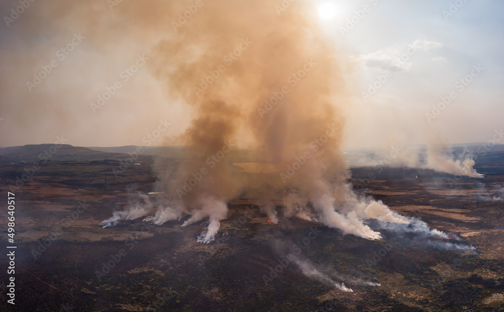 Aerial panoramic view of a large grassfire on moorland in Wales